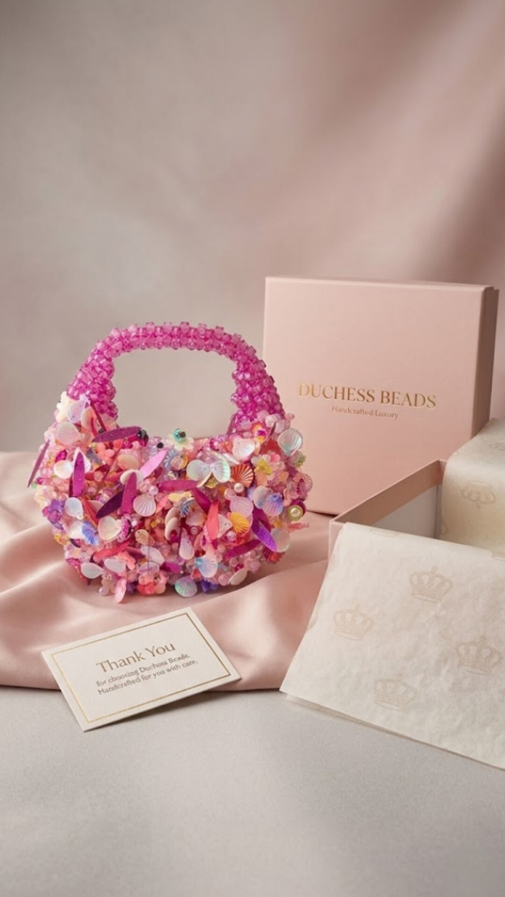 Handmade pink crystal beaded mini handbag with pearl, shell and floral embellishments by Duchess Beads Ghana.