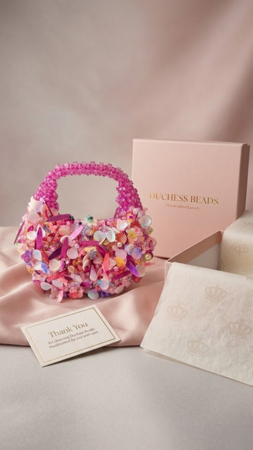 Handmade pink crystal beaded mini handbag with pearl, shell and floral embellishments by Duchess Beads Ghana.