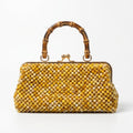 Luxury handmade golden pearl beaded bamboo handle clutch handcrafted in Ghana by Duchess Beads with gold kiss-lock closure.